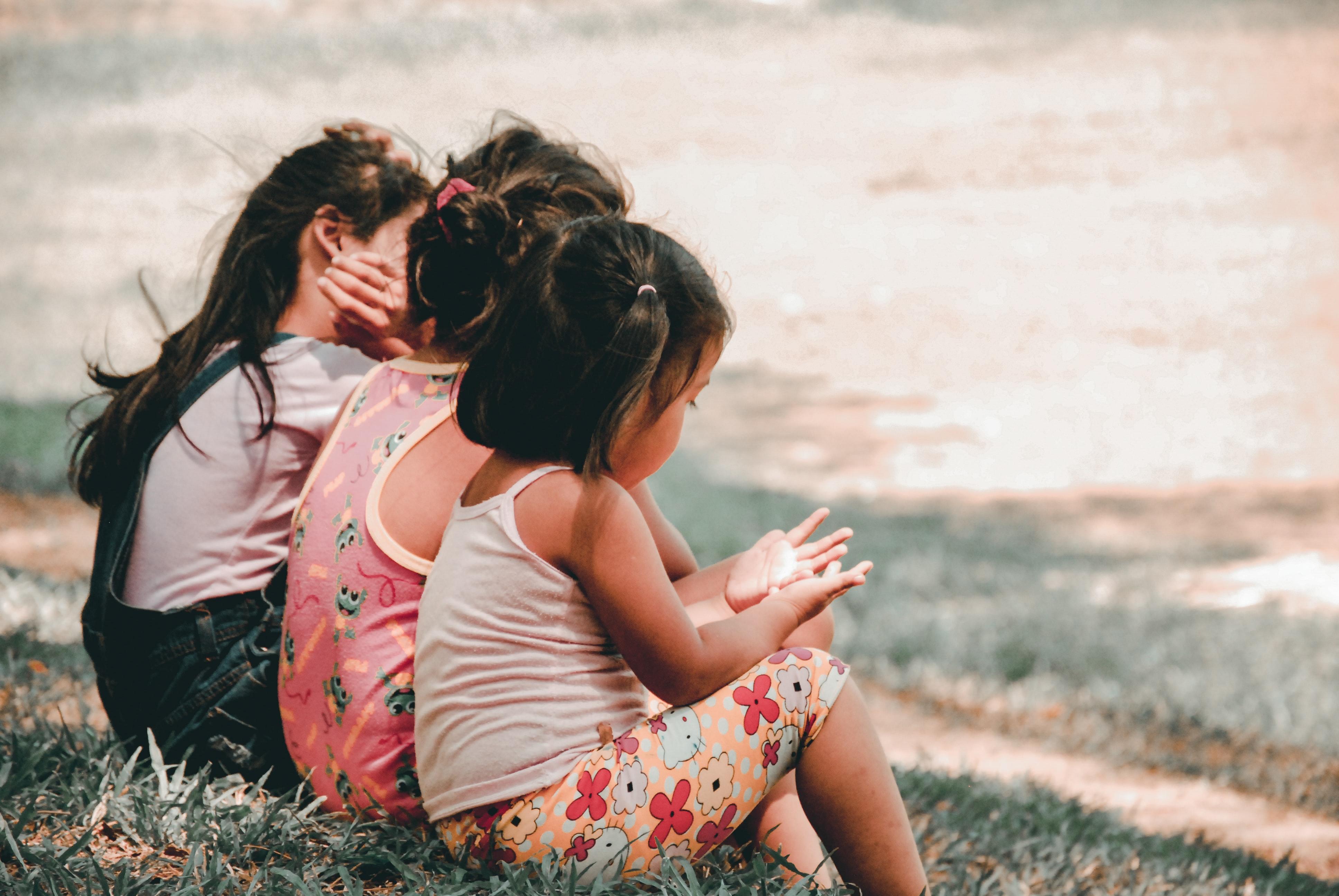 Girls sitting on a grass verge