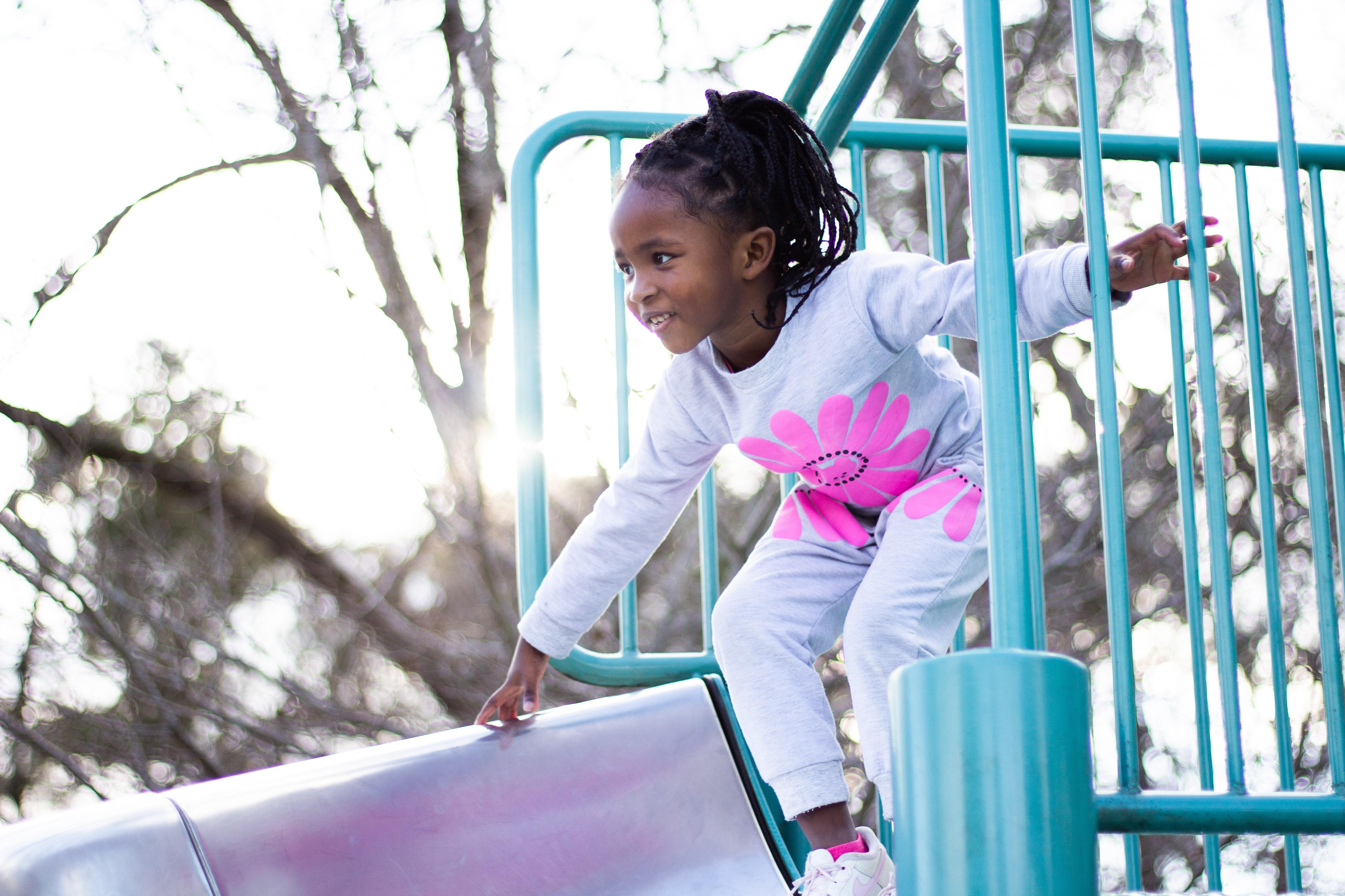 Girl on playground slide.